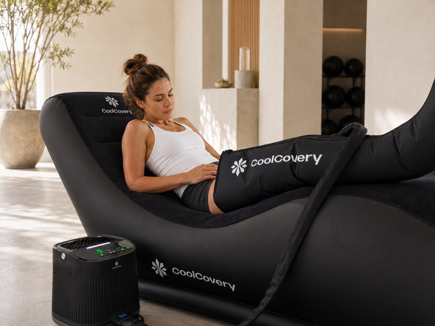 Woman using a black Coolcovery product in a modern indoor setting
