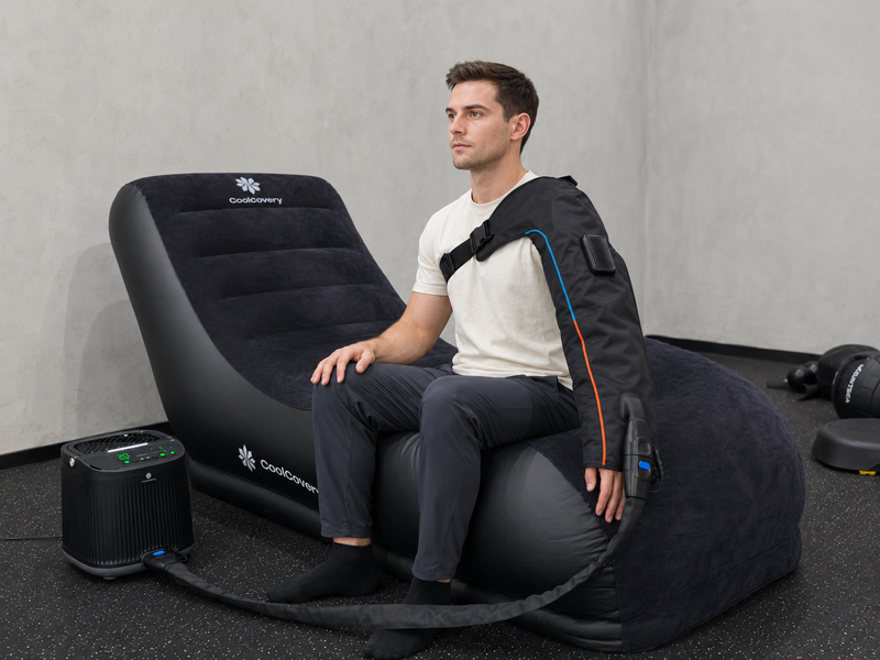 Man using a massage chair with a control panel on a gray background