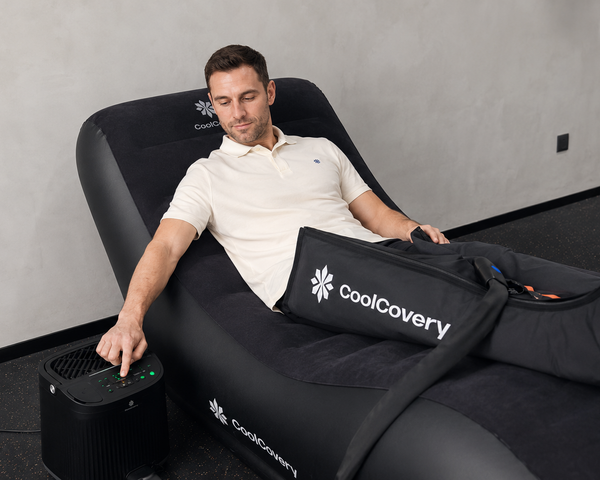 Man using a massage chair with 'CoolCavery' branding in a room.